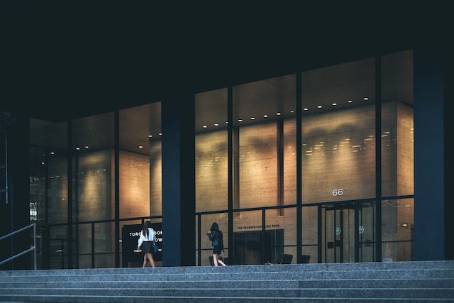 two women walking in New York at a corporate building